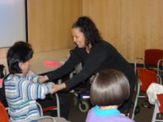 woman teaching children yoga