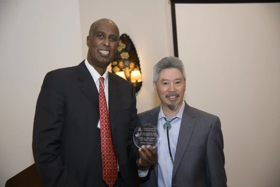 Dr. Ibrahim and Director Kwoh smiling next to each other