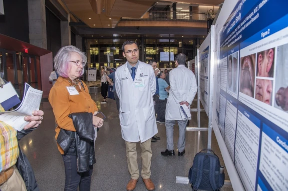 woman and professor looking at a research poster